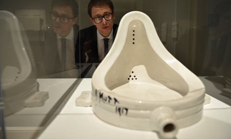 Is it art? … A gallery assistant looks at a copy of Marcel Duchamp’s 1917 work Fountain.