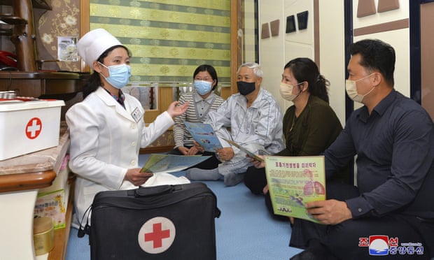 A doctor visits a family to raise awareness of Covid-19, in Pyongyang, North Korea  