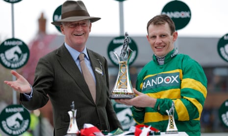 Jockey Paul Townend and trainer Willie Mullins with the winners trophy after victory with I Am Maximus in the 2024 Grand National.