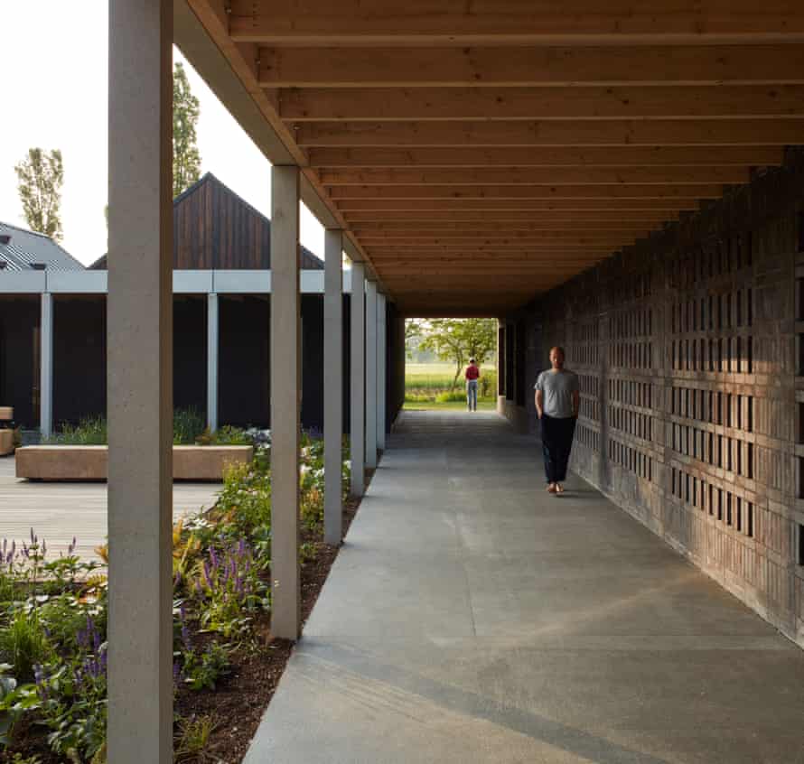 ‘A handsome facility a world away from the former makeshift barns’ … retreat attendees on a walkway.