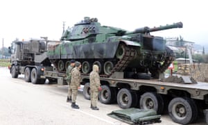 A Turkish tank is moved to the Syrian border in preparation for the attack.