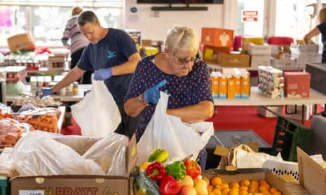 Volunteers sort food into parcels at the Rumney Forum community charity in Cardiff.