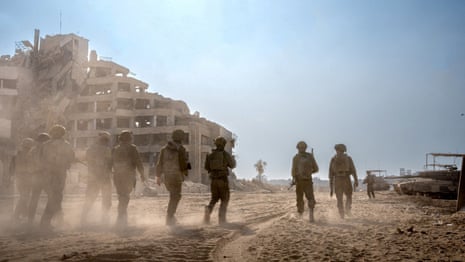 This handout picture released by the Israeli army on 3 January shows Israeli soldiers operating at an undisclosed location in the Gaza Strip.