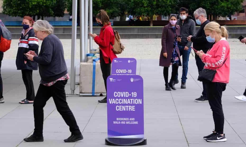 People line up to get vaccinated for Covid-19 outside the Royal Exhibition Building in Carlton, Melbourne.