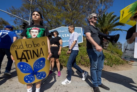 Protesters stand outside Dodger Stadium in Los Angeles, California, to protest Ice raids, on 19 June 2025.