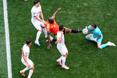 Belgium's Romelu Lukaku challenges Iran goalkeeper Alireza Beiranvand.