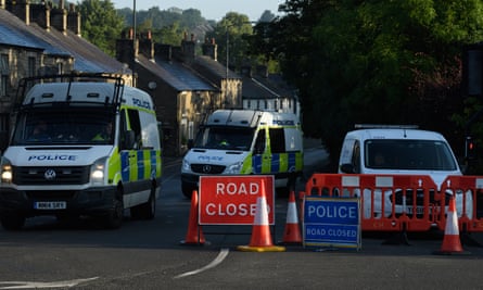 Police vehicles block the road near Toddbrook reservoir