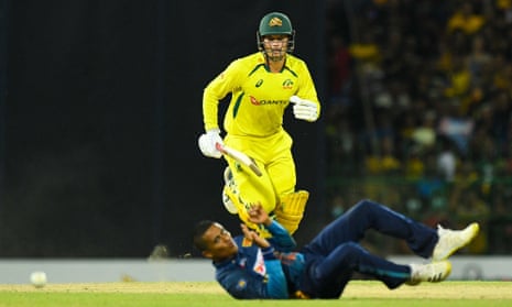 Alex Carey runs between the wickets as Sri Lanka's Jeffrey Vandersay dives to field.