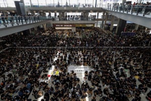 Protesters surround banners that read: ‘Those on the street today are all warriors!’ centre top, and ‘Release all the detainees!’