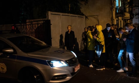 The Swedish ambassador to Belarus, Christina Johannesson (centre) arrives at a police station in Minsk to collect photographer Paul Hansen after his release