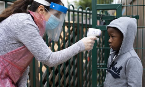 A member of staff takes a child’s temperature at the Harris Academy’s Shortland’s school in London. The Delve report stresses the need for thorough hygiene and social distancing in schools.