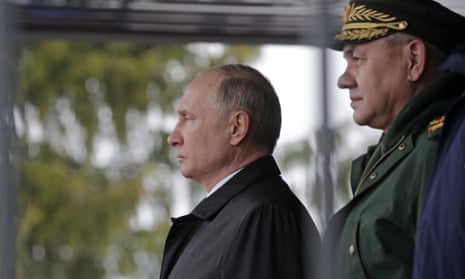 Vladimir Putin, left, at an event commemorating paratroopers killed in the second Chechen war