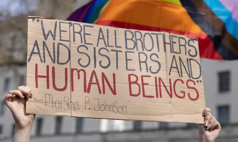 A sign saying '"We're all brothers and sisters and human beings" – Marsha P Johnson',  at a demonstration in London against the UK government's decision not to ban conversion therapy for transgender people