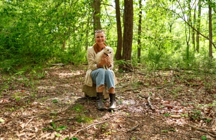 Elizabeth Gilbert, author of Eat, Pray, Love, sitting in a forest, holding a dog