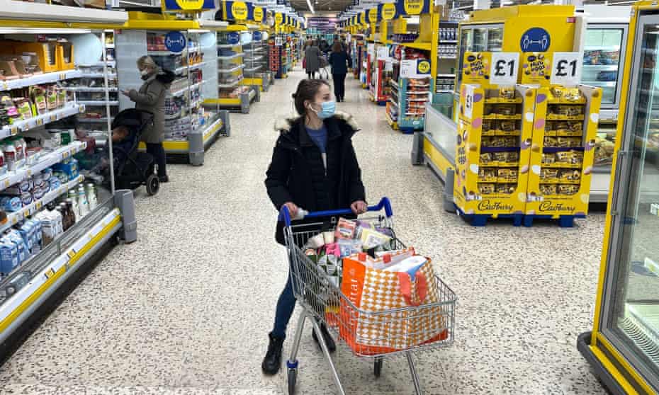 Woman with a shopping trolley in a Tesco