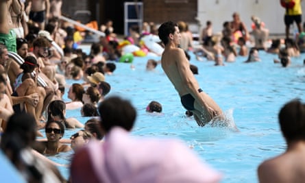 Lots of people surrounding and in a pool