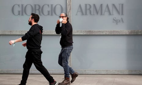 workers outside Giorgio Armani sign