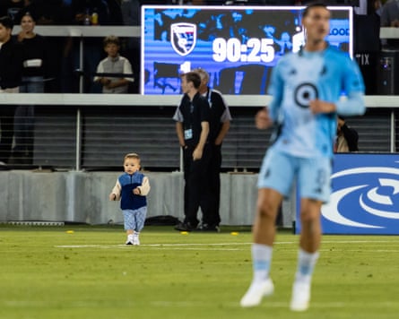 A young child walking out on to a playing field