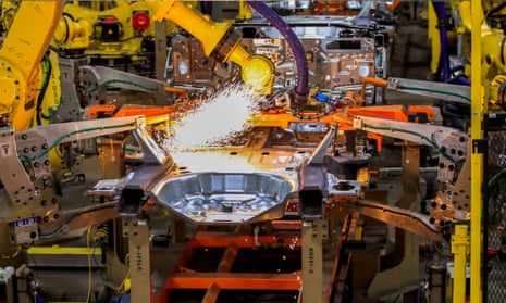Sparks fly as robots spot weld vehicle chassis at the Ford plant in Chicago.