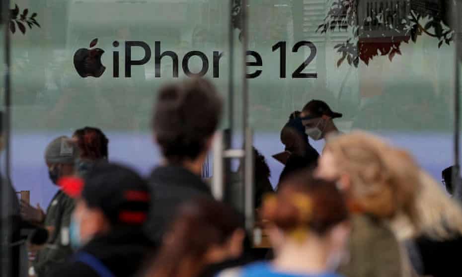 Customers wait in line outside an Apple Store to pick up the new 5G iPhone 12 in Brooklyn, New York on 23 October 2020. 