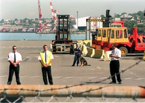 Private security personnel and dogs keep watch on several thousand fired waterfront workers and other union supporters that marched in front of Sydney’s Darling Harbour docks in April 1998.