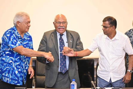 Fiji’s new prime minister Sitiveni Rabuka (centre) joins hands with coalition partners, Biman Prasad (right), of the National Federation Party, and Anare Jalu, of the Social Democratic Liberal Party (SODELPA).