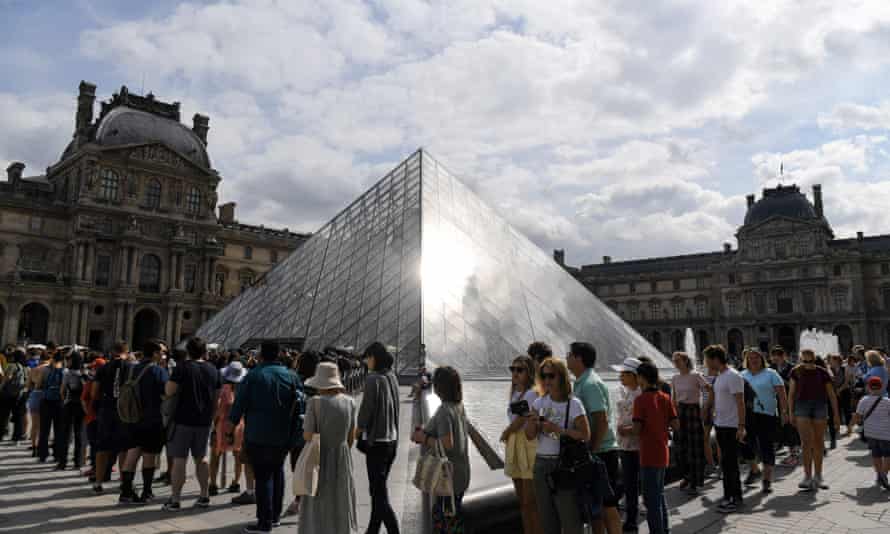 People queue at the Louvre museum hoping to see the Mona Lisa.