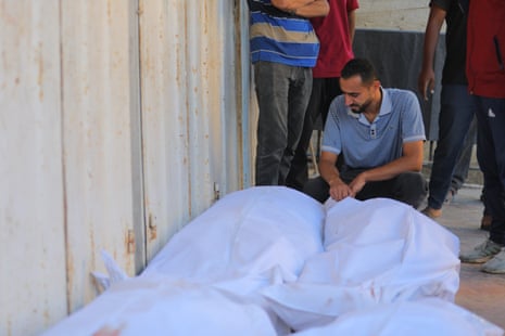 Palestinian people mourn the loss of their loved ones killed in an Israeli attack despite the ceasefire agreement, at Al Awda hospital in Nuseirat.