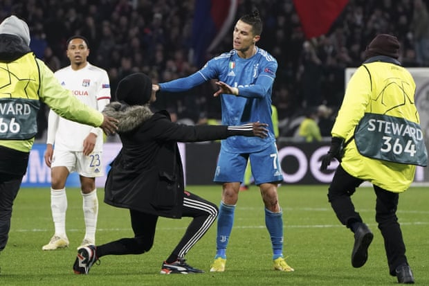A fan kneels before Cristiano Ronaldo during Juventus’s game at Lyon in February 2020