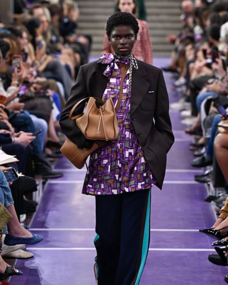 A model on the catwalks wears a blazer with tracksuit bottoms