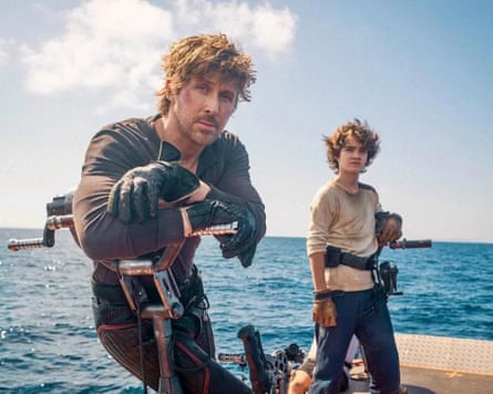 Ryan Gosling and Flynn Gray stand on a boat deck holding futuristic weapons, overlooking the ocean