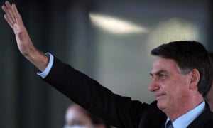 Brazil’s President Jair Bolsonaro waves
