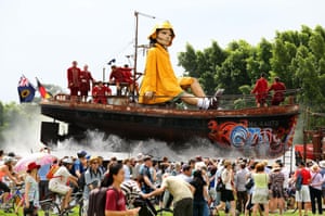 The giant sits on top of a boat while travelling down Plain Street.