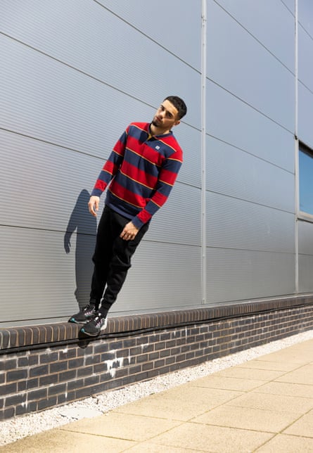 Kid Karam leaning at an angle off a wall