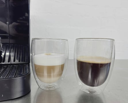 Two types of short coffee drink in closeup next to the De’Longhi Magnifica Start machine.
