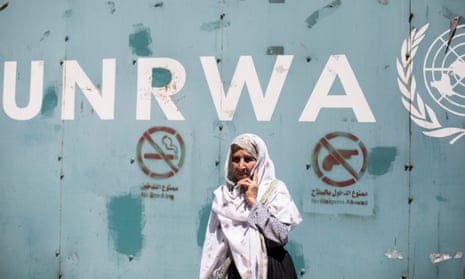 An elderly female protester stands outside the gate of the UN Relief and Works Agency office in Gaza
