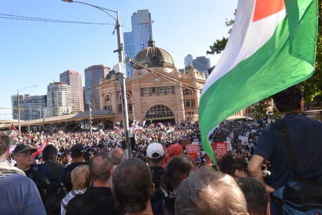 People gather outside Flinders Street Station to protest against a visit to Melbourne by Israeli president Isaac Herzog.