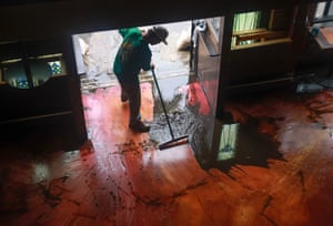 a man sweeps mud