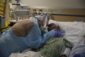 Romelia Navarro, 64, weeps while hugging her husband, Antonio, in his final moments in a COVID-19 unit at St. Jude Medical Center in Fullerton, Calif., on July 31, 2020.