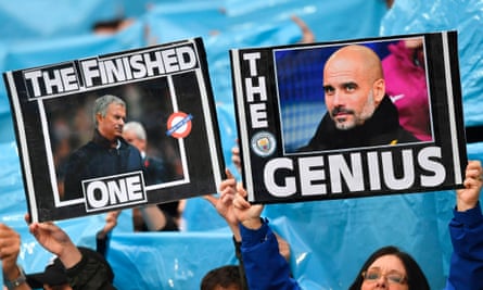 Manchester City fans hold up placards in April 2018
