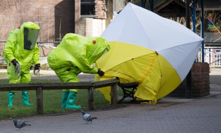 Specialist officers in protective suits secure the police forensic tent covering the bench where Sergei and Yulia Skripal were found critically