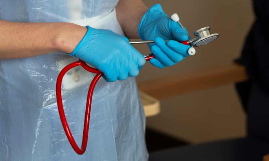 A doctor's hands holding a stethoscope