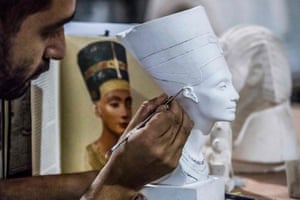 A technician crafts a replica of a bust of Queen Nefertiti