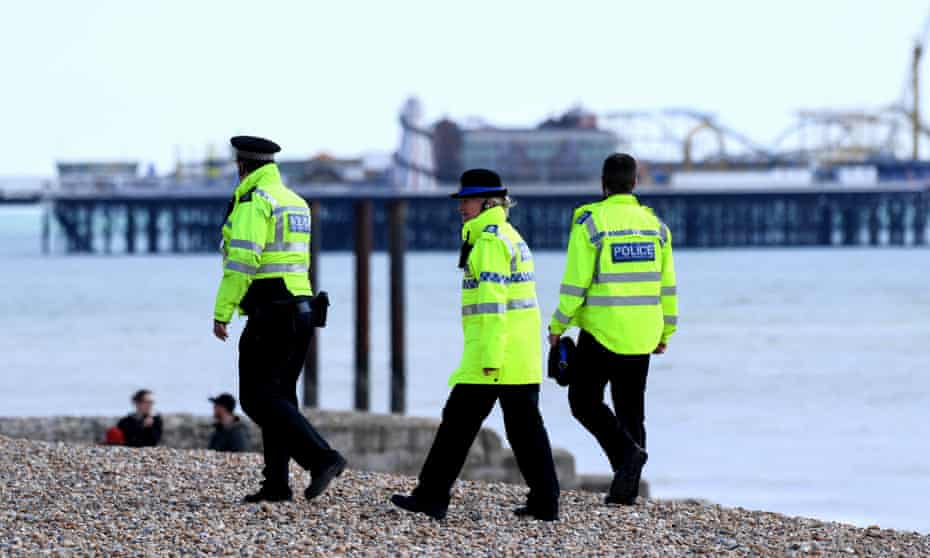 Police officers patrol Brighton beach, 31 March 2020. 