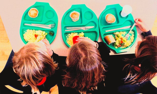 Three children eat their school lunch