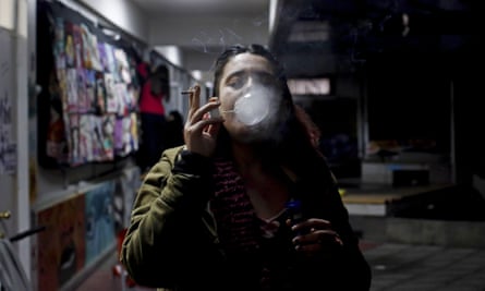 Francisca, a 19-year-old student, makes soap bubbles with cigarette smoke in the courtyard of he Metropolitan Technological University, in Santiago, Chile, on 31 May.