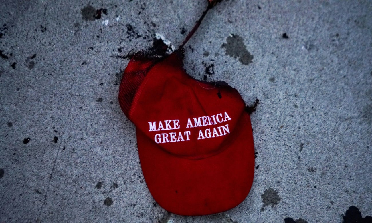 A burnt Make America Great Again (Maga) hat lies on the ground during a protest against racial injustice near the site of a rally by Donald Trump in Tulsa, Oklahoma, on 20 June 2020.