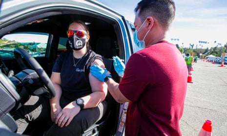 Ashley Van Dyke receives a Covid-19 shot as a mass-vaccination of healthcare workers takes place at Dodger Stadium in Los Angeles