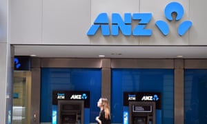 A pedestrian walks past ANZ bank