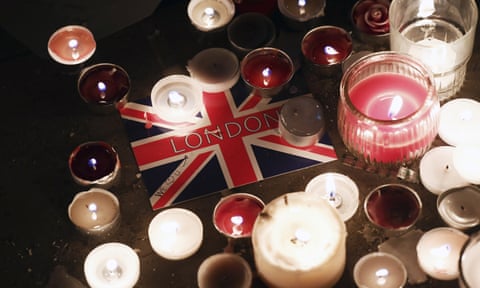A London postcard amongst candles during a vigil in Trafalgar Square.